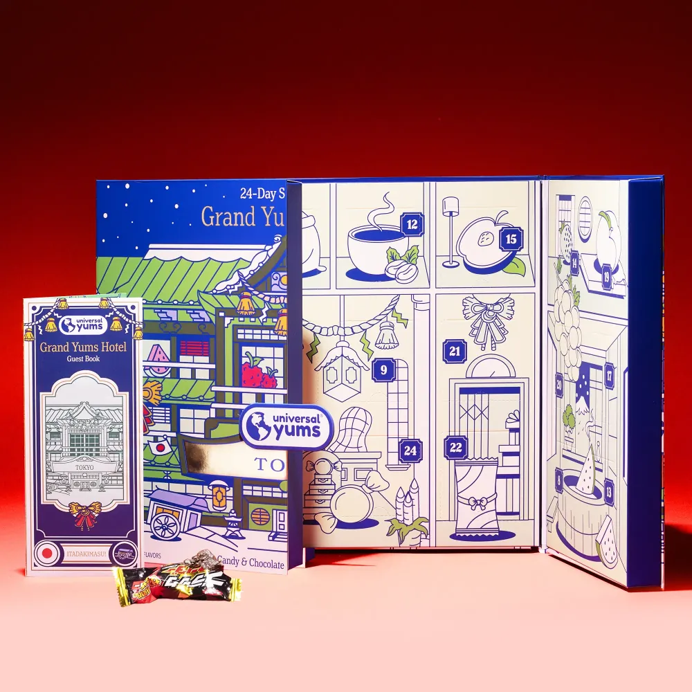 The Grand Yums Hotel Tokyo advent calendar opened to its numbered doors, with its guest book and a Japanese candy.