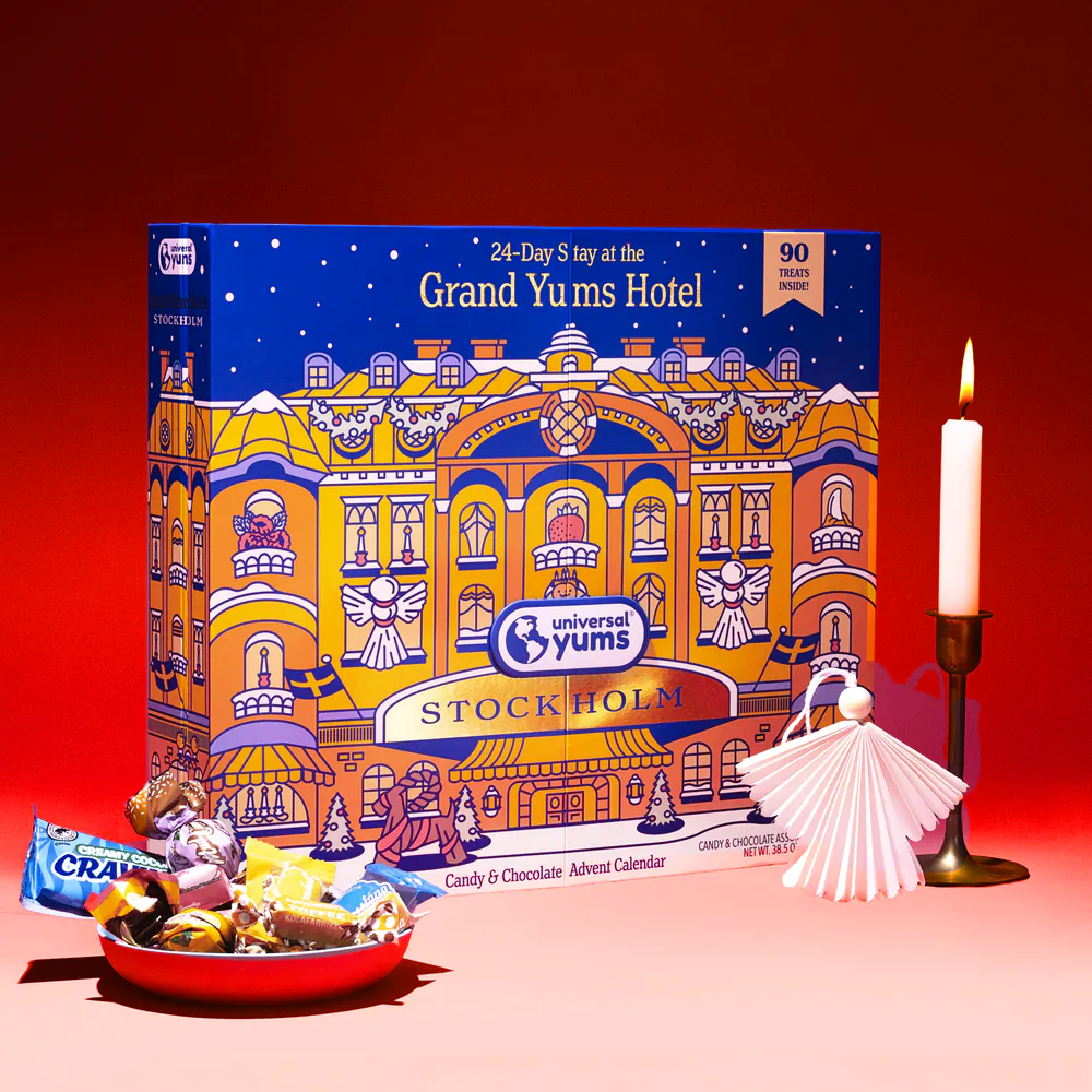 The Grand Yums Hotel Stockholm advent calendar with a bowl of Swedish candy, a candle and a paper angel.