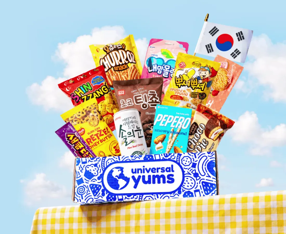 Universal Yums box overflowing with snacks under a blue sky